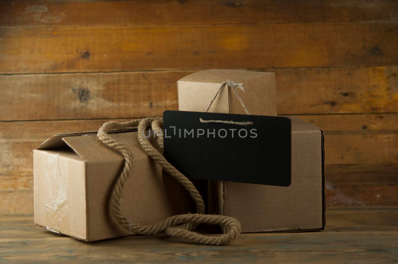 Pile cardboard boxes on a wooden background by inxti