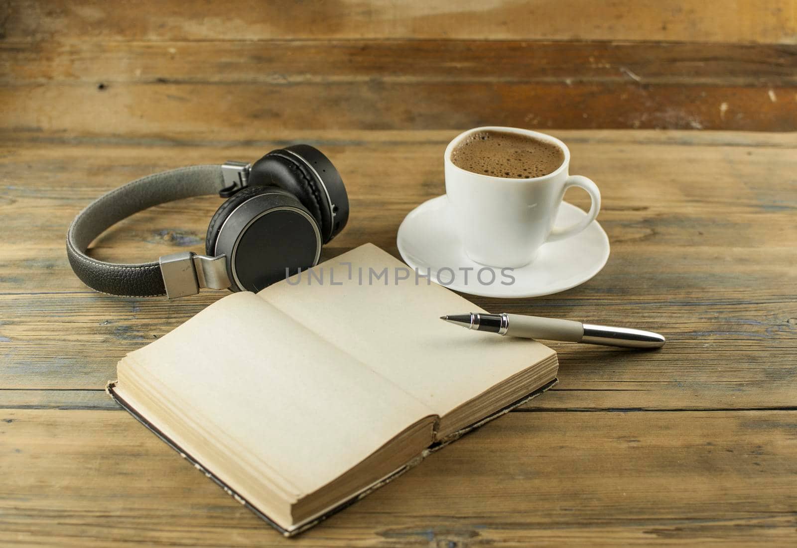 open book with blank pages next to cup of coffee on wooden table. ready for adding text or mockup
