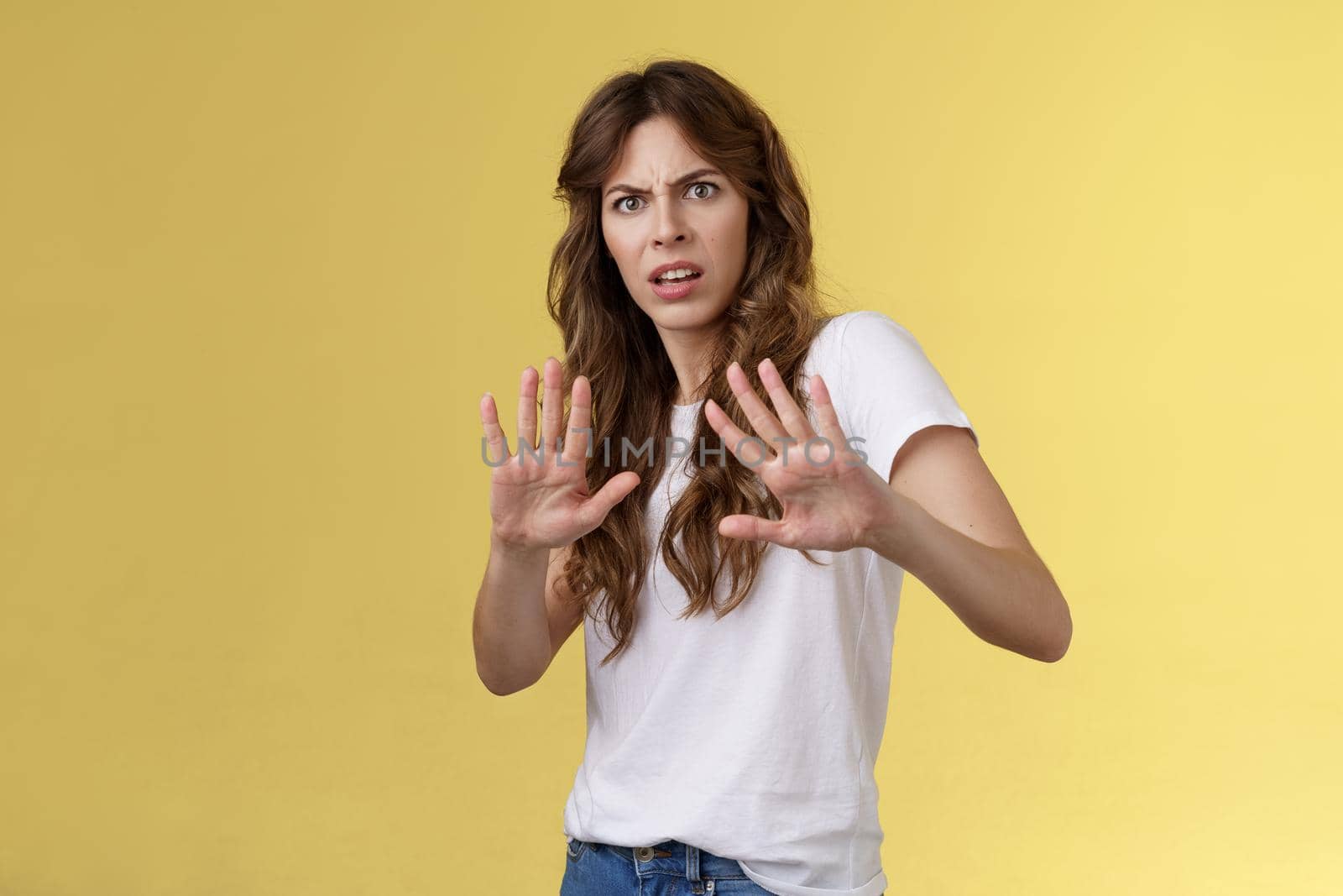 Back up I said no. Ignorant bothered displeased intense serious woman cringe grimacing disgusted step back hold hands stop enough rejection gesture express aversion demand not come closer.