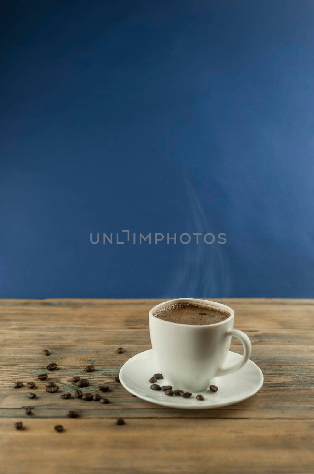 Cup of coffee with roasted beans on a wooden table. by inxti