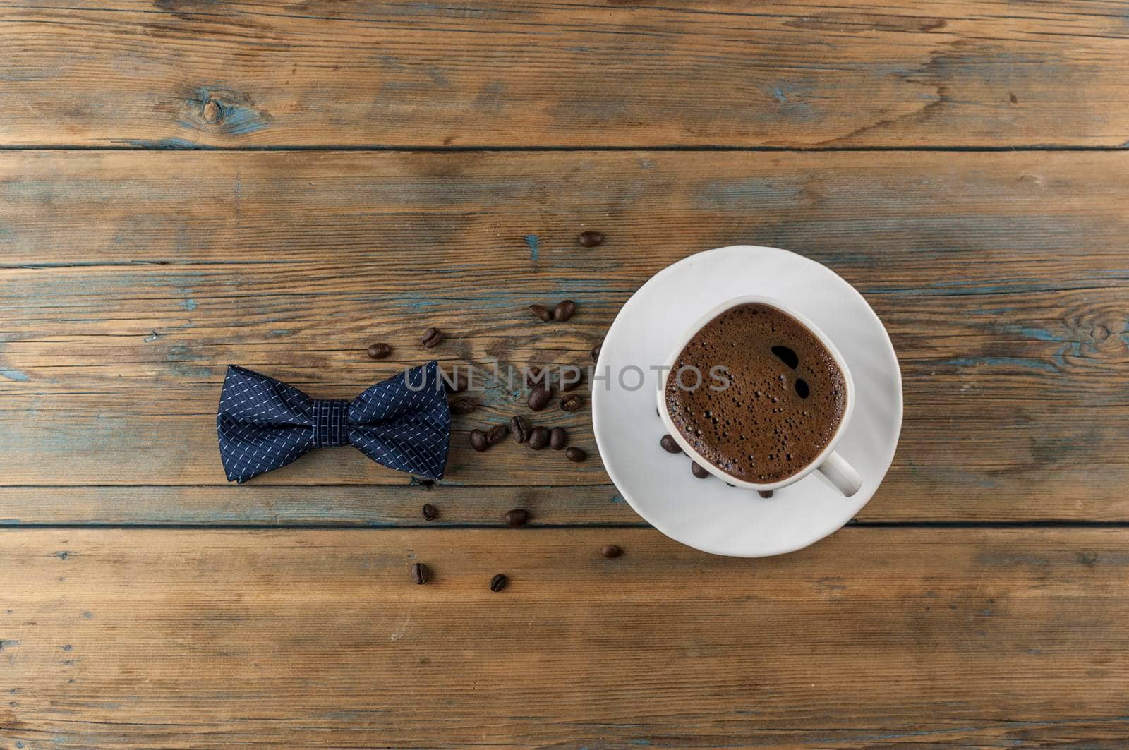 Cup of coffee with roasted beans on a wooden table. by inxti