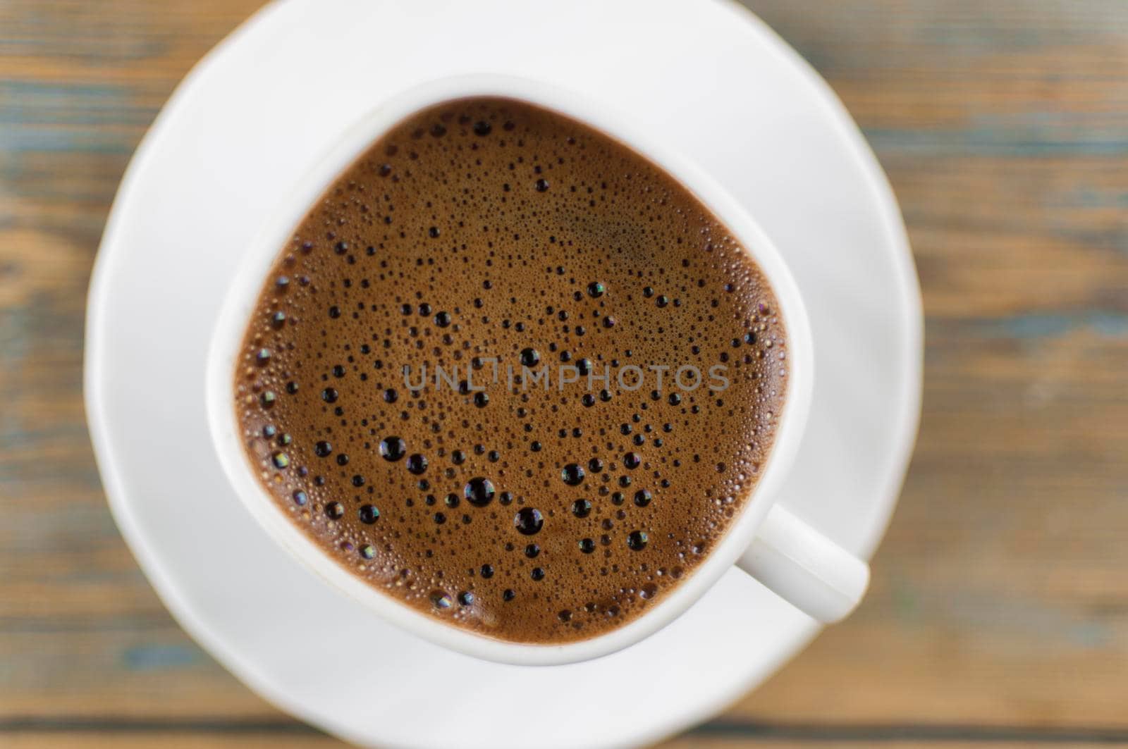 Top view of coffee cup on a wood background with copy space. Close up