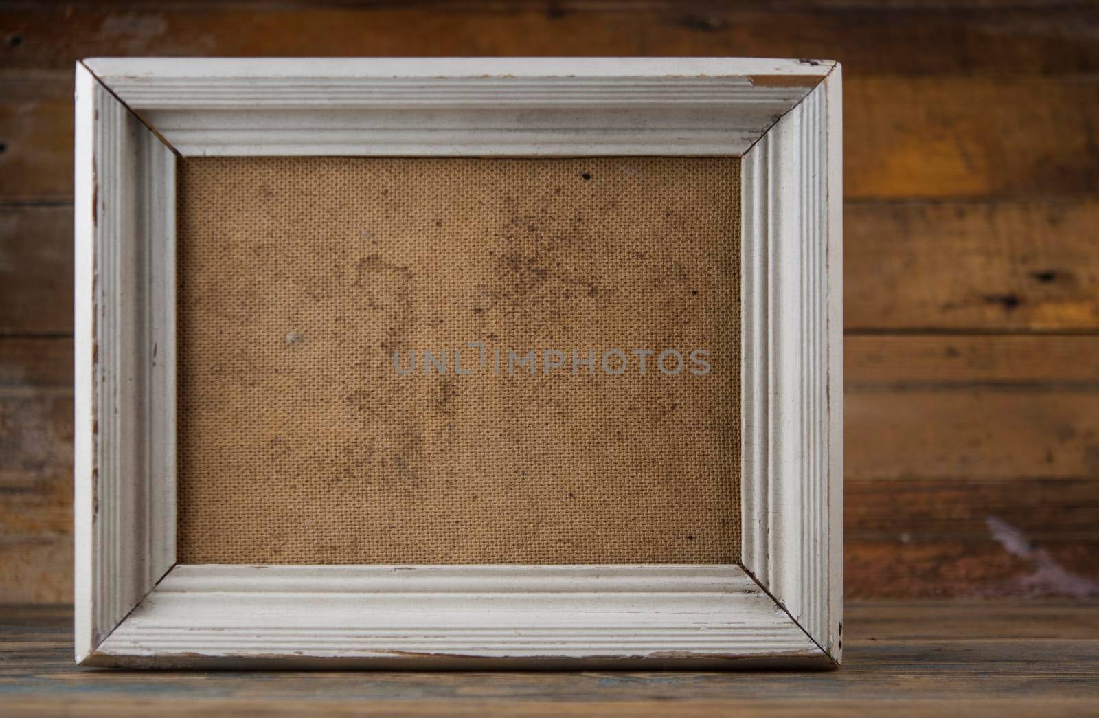 Blank old wooden frame on parquet floor
