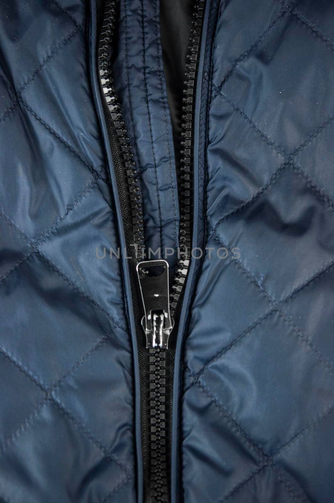 The lock with a zipper is close-up on the clothes color. Zipper with lock. by inxti
