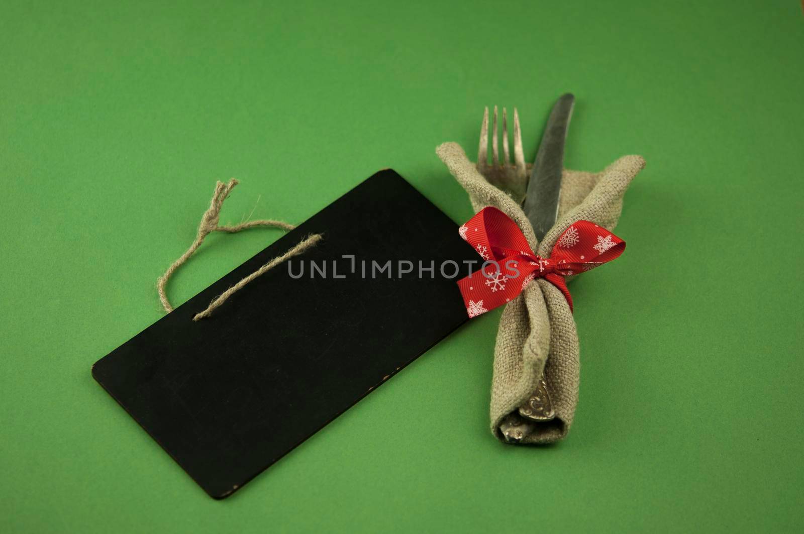 Vintage silverware decorated with red ribbon. Christmas menu. Copy space.