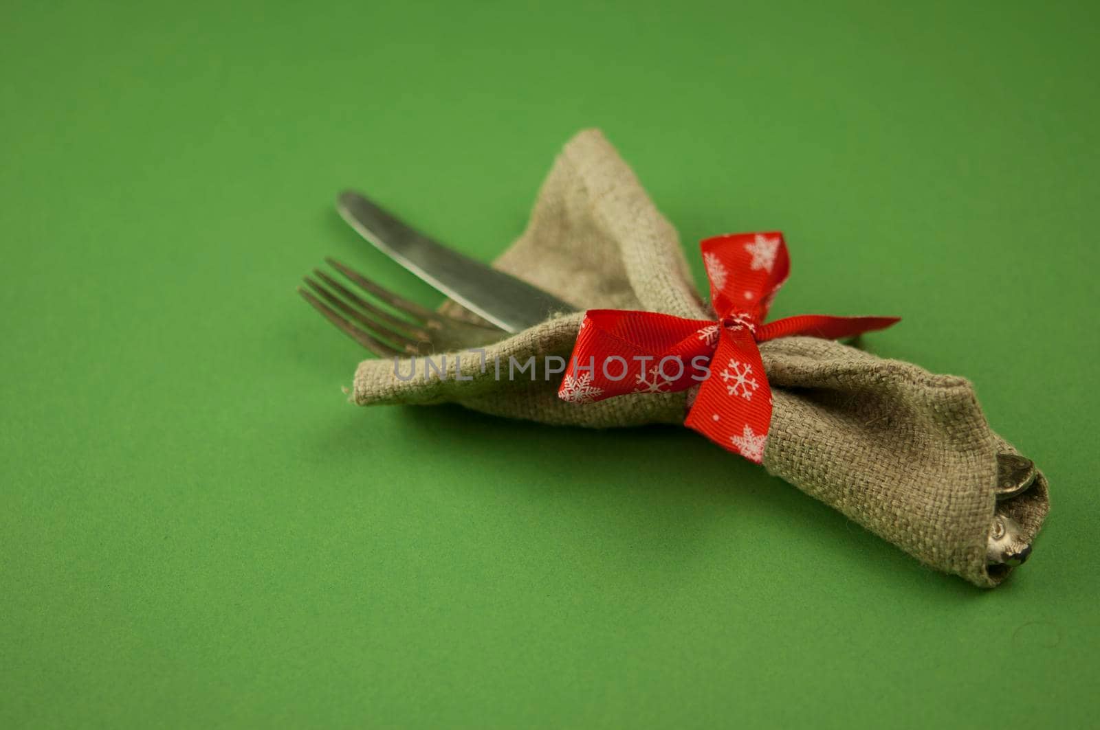 Vintage silverware decorated with red ribbon. Christmas menu. Copy space.