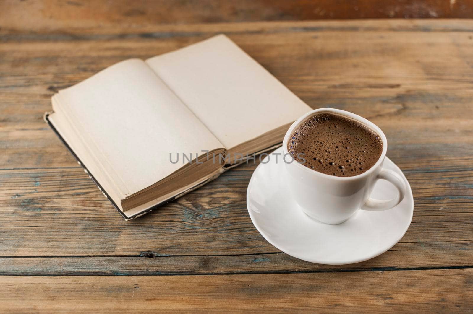 Open a blank page book and cup of coffee on the desk by inxti