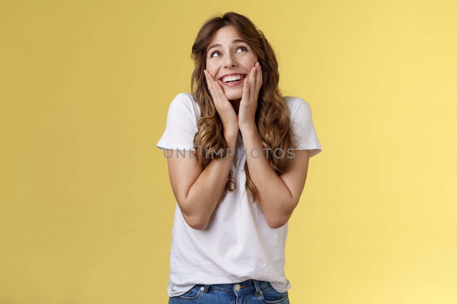 Dreamy flirty feminine cute female curly hairstyle sighing lovely admiration look up smiling broadly touch cheeks blushing recall heartwarming romantic date express tempation joy yellow background by Benzoix