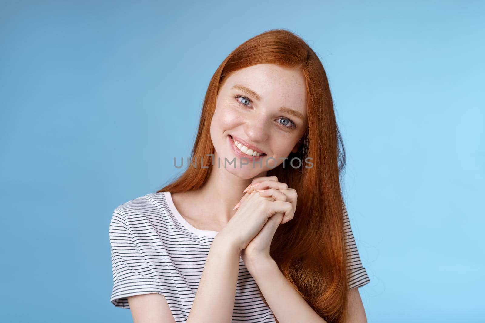 Romantic tender lovely redhead girlfriend tilting head press palms together smiling touched look sympathy check out cute picture friend standing delighted amused, heartwarming moment.