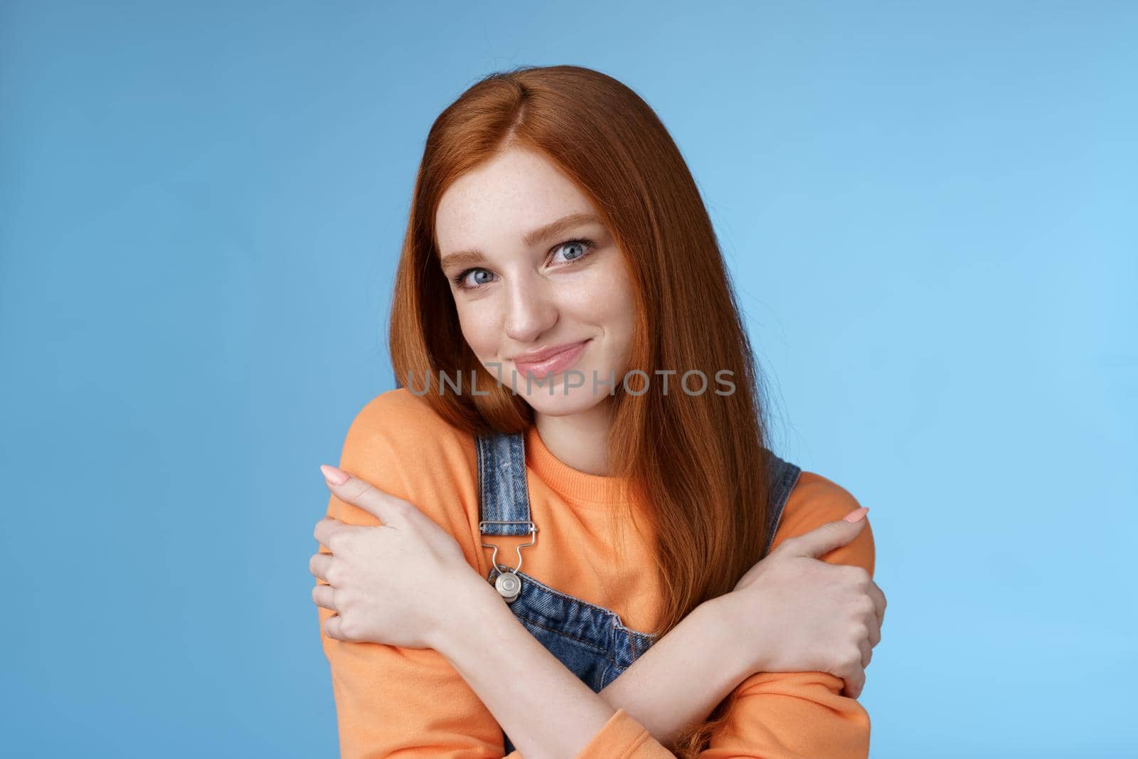 Romantic sensitive flirty young redhead girlfriend feel warmth embraces hugging herself hands crossed body tilting head smiling safe gentle, dreaming lovely date recalling sensual moments.