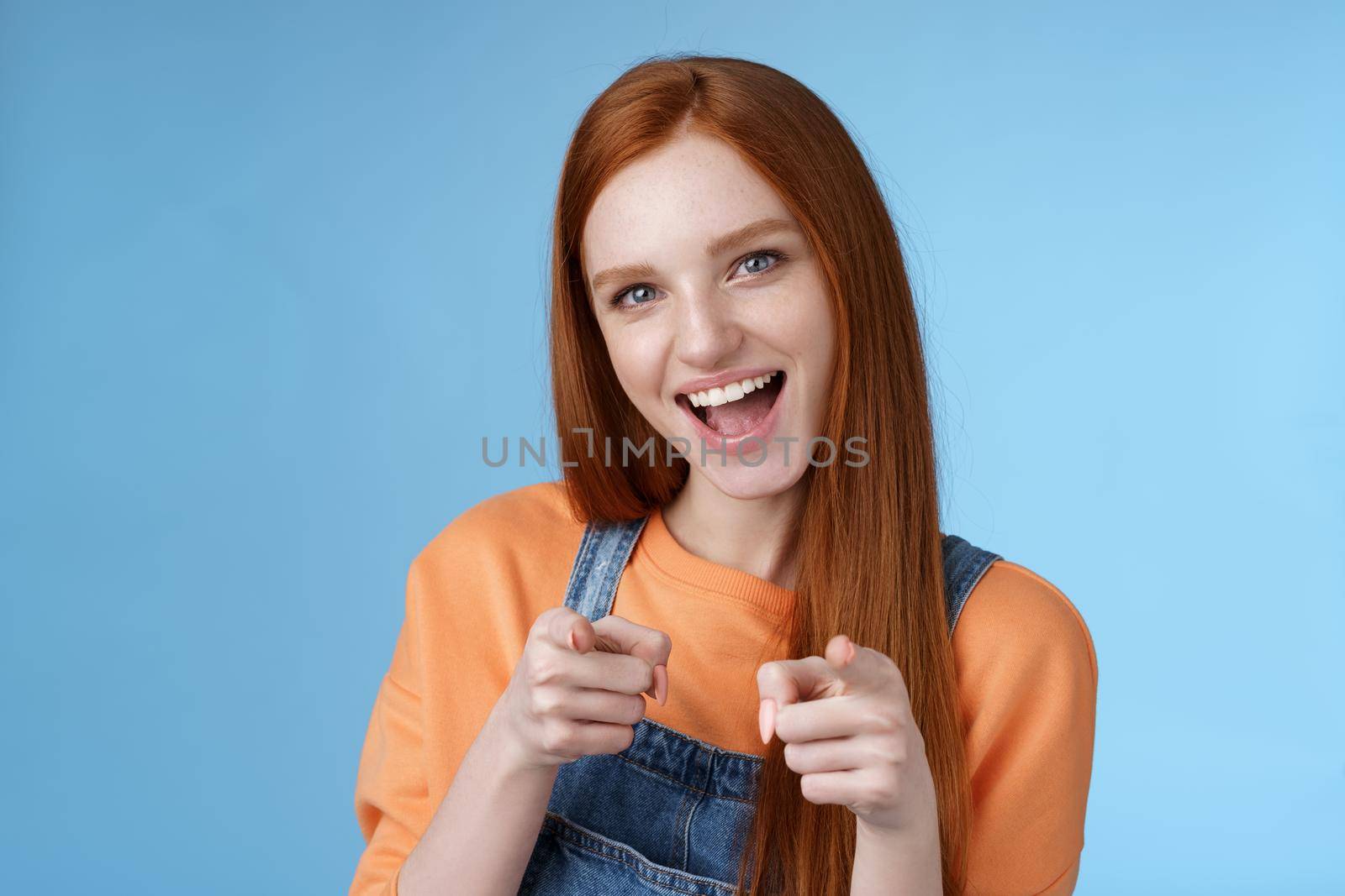 My congrats. Sassy confident enthusiastic young attractive ginger girl blue eyes pointing finger pistols camera smiling broadly cheering friend did great job congratulate you awesome performance by Benzoix