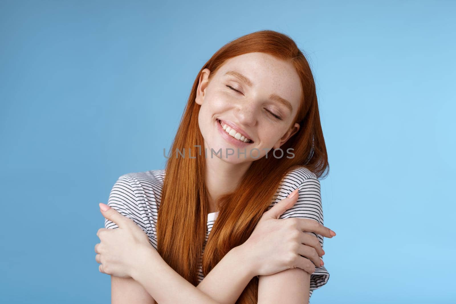 Tender romantic cute young gentle redhead girlfriend close eyes dreamy lean shoulder cross arms around chest cuddling recalling nice memory feel warmth comfort hugging daydreaming smiling by Benzoix