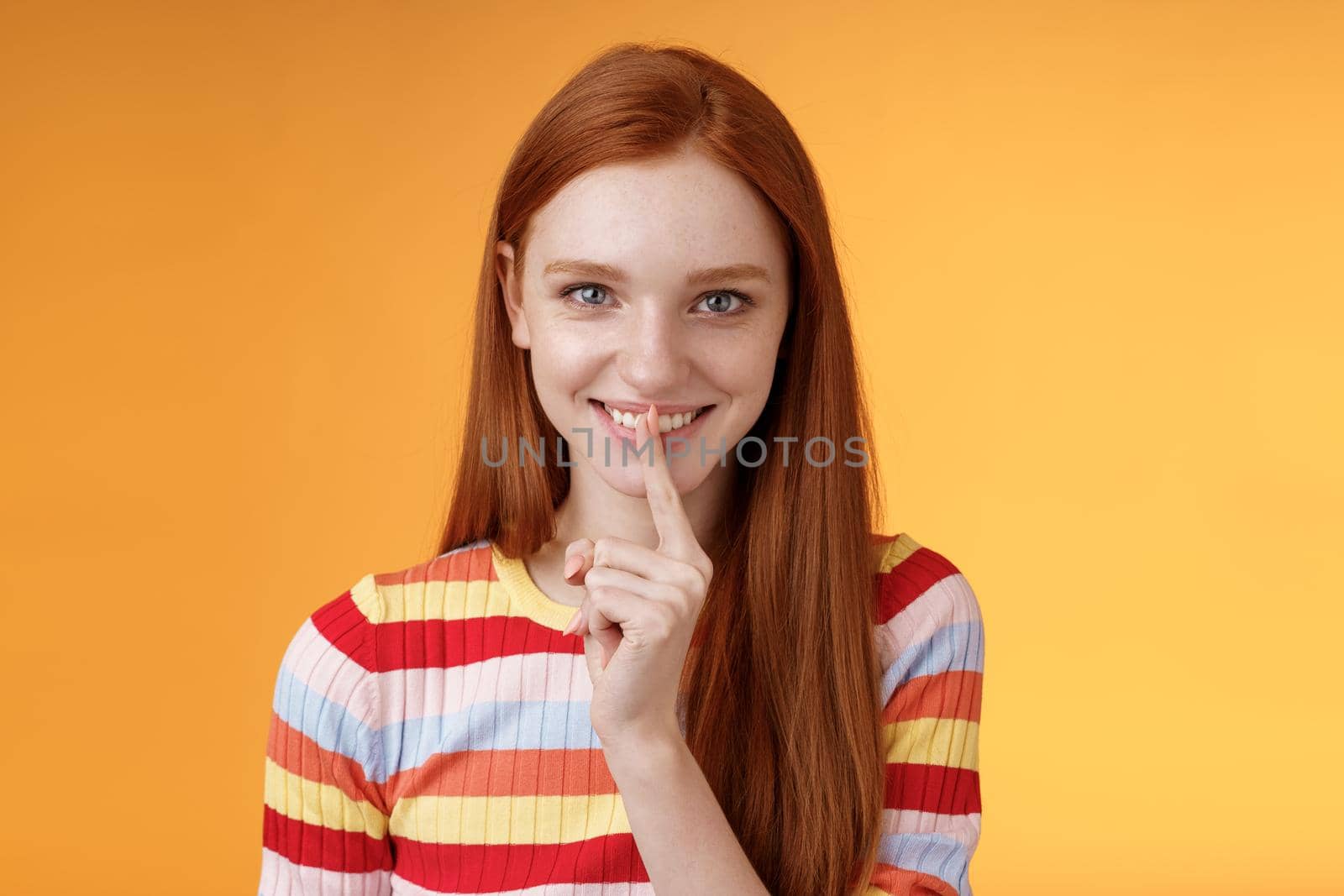 Flirty devious creative young redhead smiling excited ginger girl prepare mysterious gift surprise party giggling tricky say shush shhh gesture index finger mouth grinning delighted, have idea by Benzoix