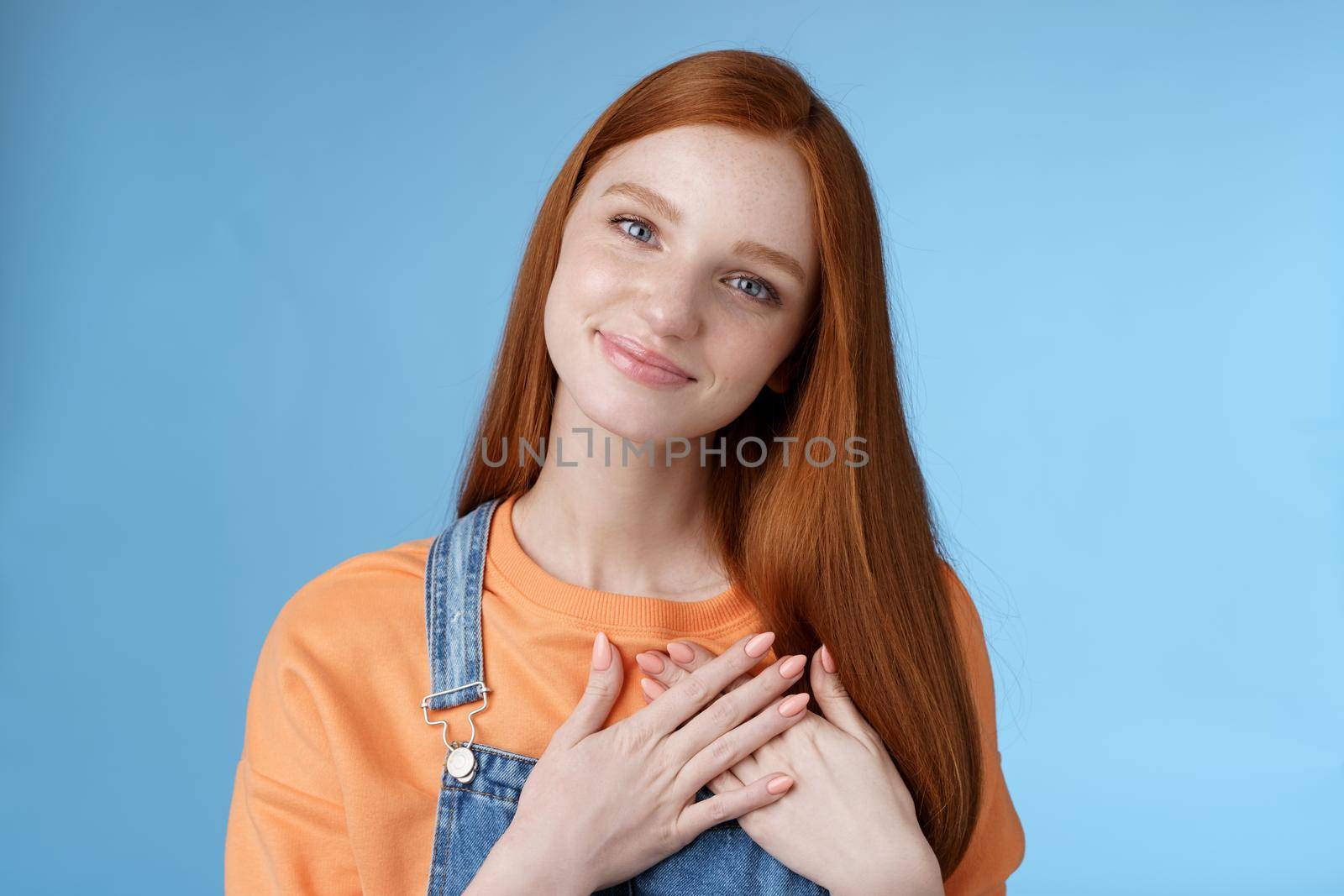 Touched romantic tender cute redhead feminine girl blue eyes tilting head melting heartwarming gesture receive gladly pleasant prest touch heart smiling grateful, feel romance love, blue background by Benzoix