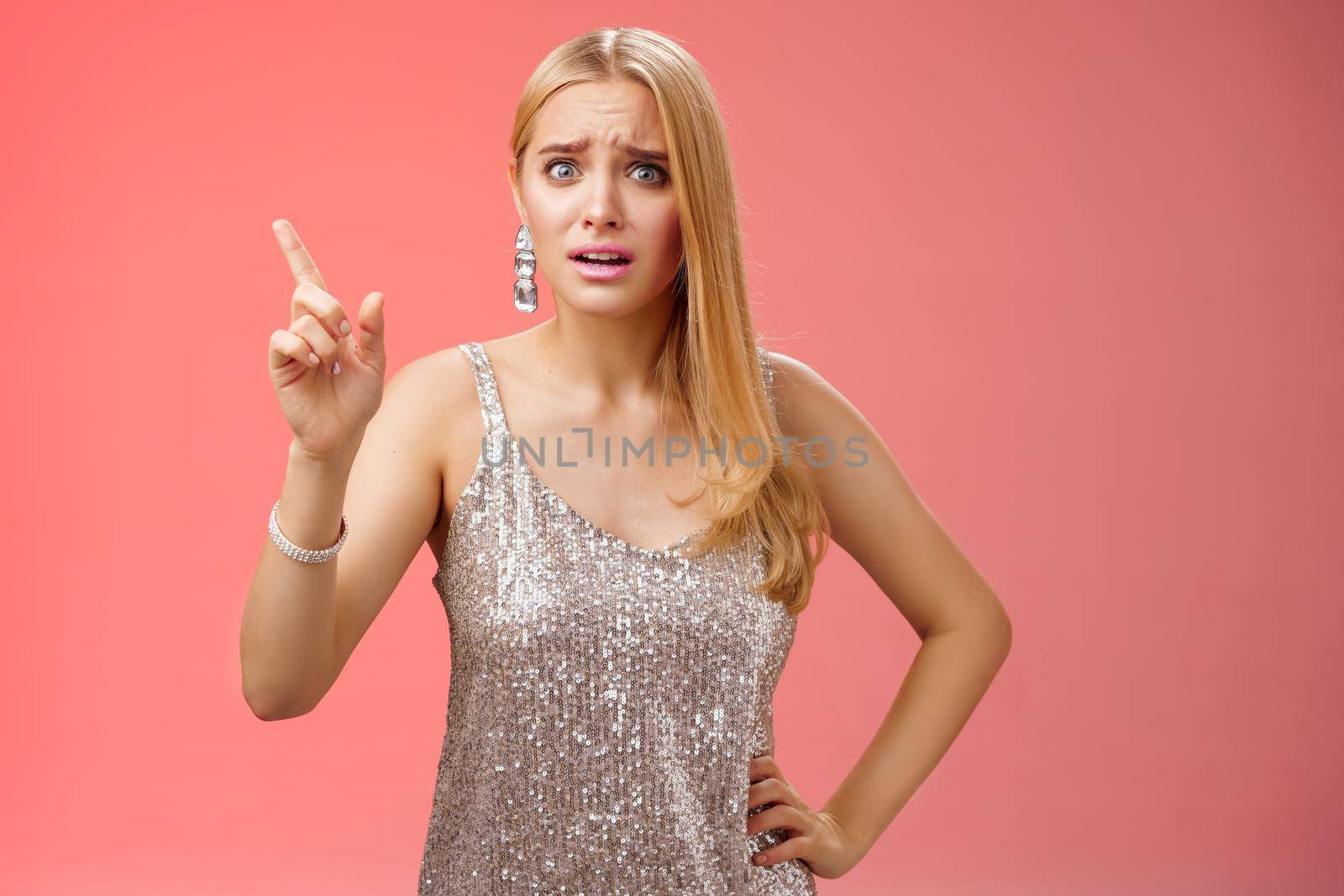 How could you. Disappointed let down upset complaining young woman demanding respect raise index finger scolding teaching lesson give instructions standing bothered displeased, red background.