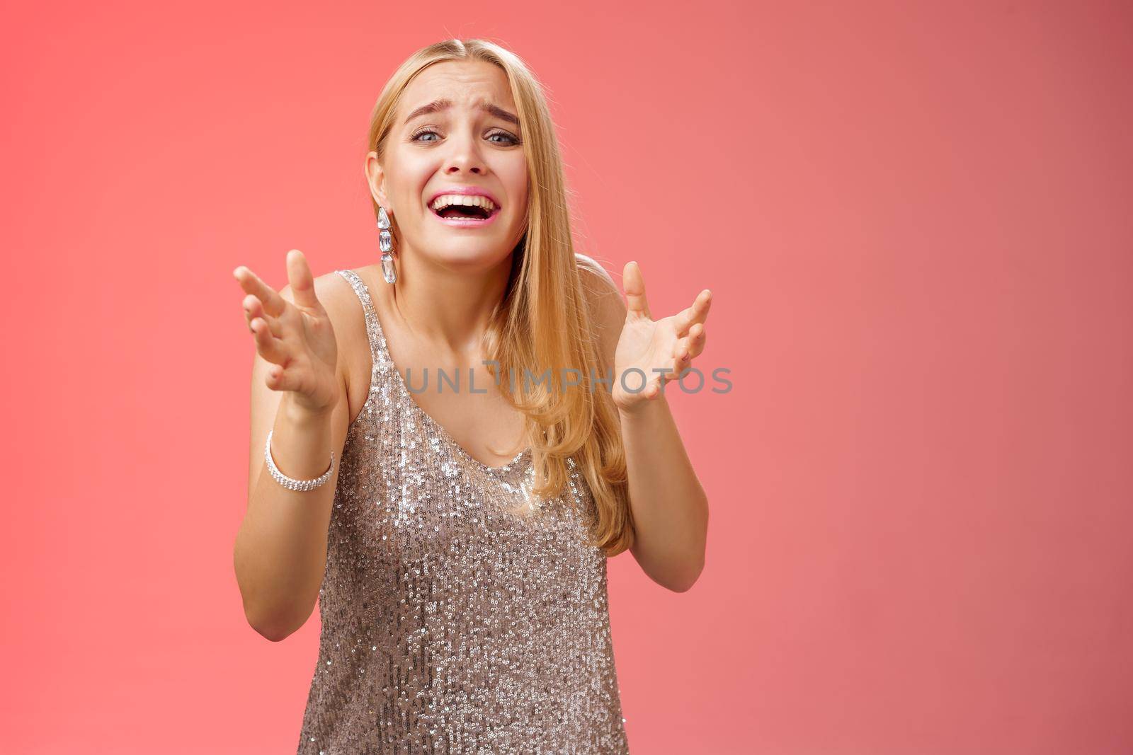 Lifestyle. Panicking upset miserable heartbroken blond girl crying raising hands begging not go broke-up boyfriend look sorrow distressed freak-out standing devastated red background during party.