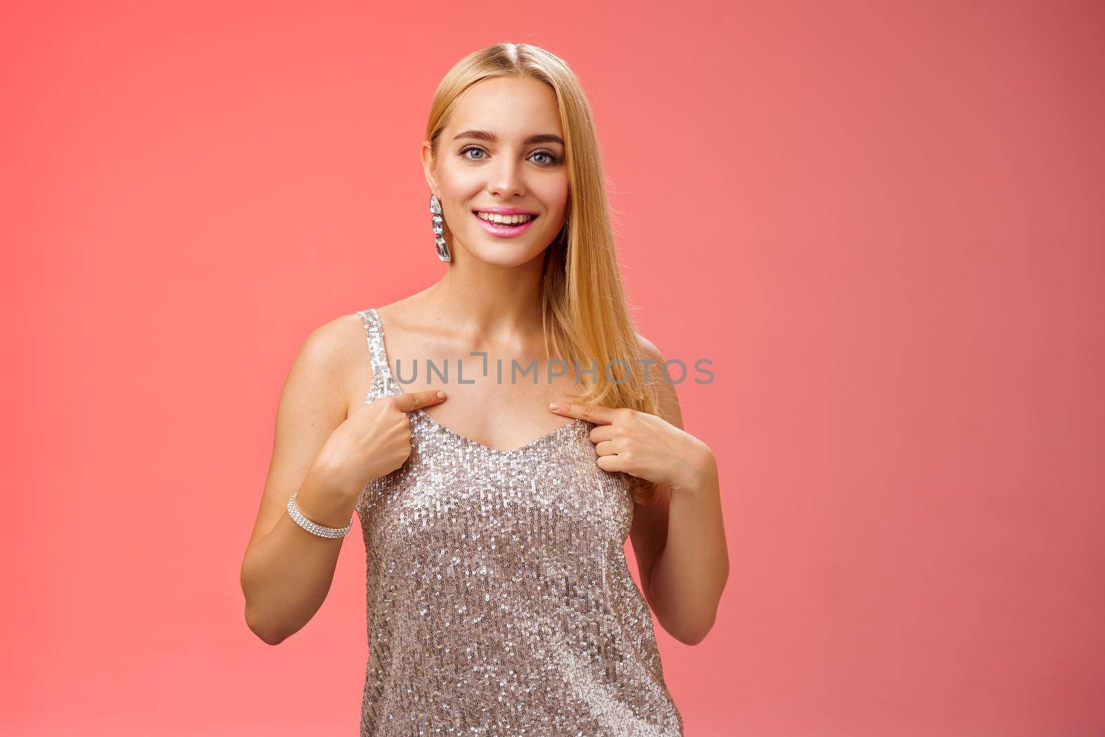 Boastful good-looking confident blond european woman in silver luxurious dress pointing herself smiling proudly bragging talking own accomplishments goals standing red background self-assured by Benzoix
