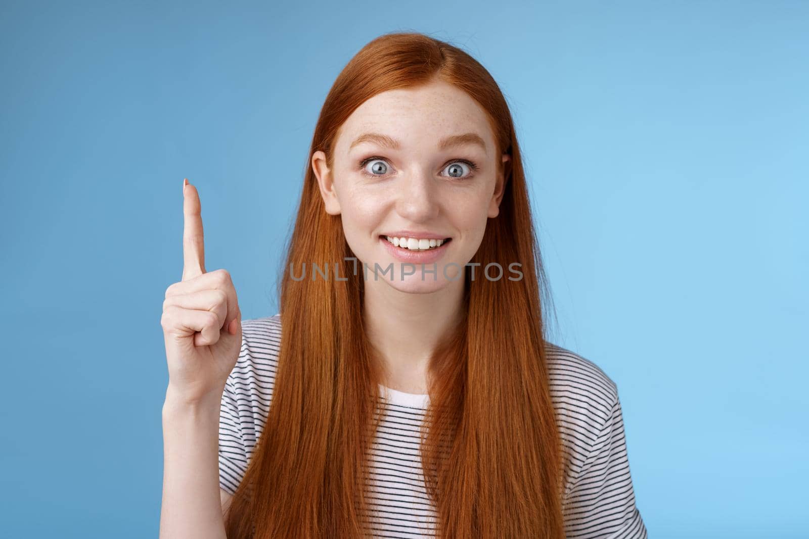 Girl made excellent suggestion think up great idea raising index finger eureka got it gesture smiling thrilled wanna share plan team speaking look camera excitement joy, standing blue background.