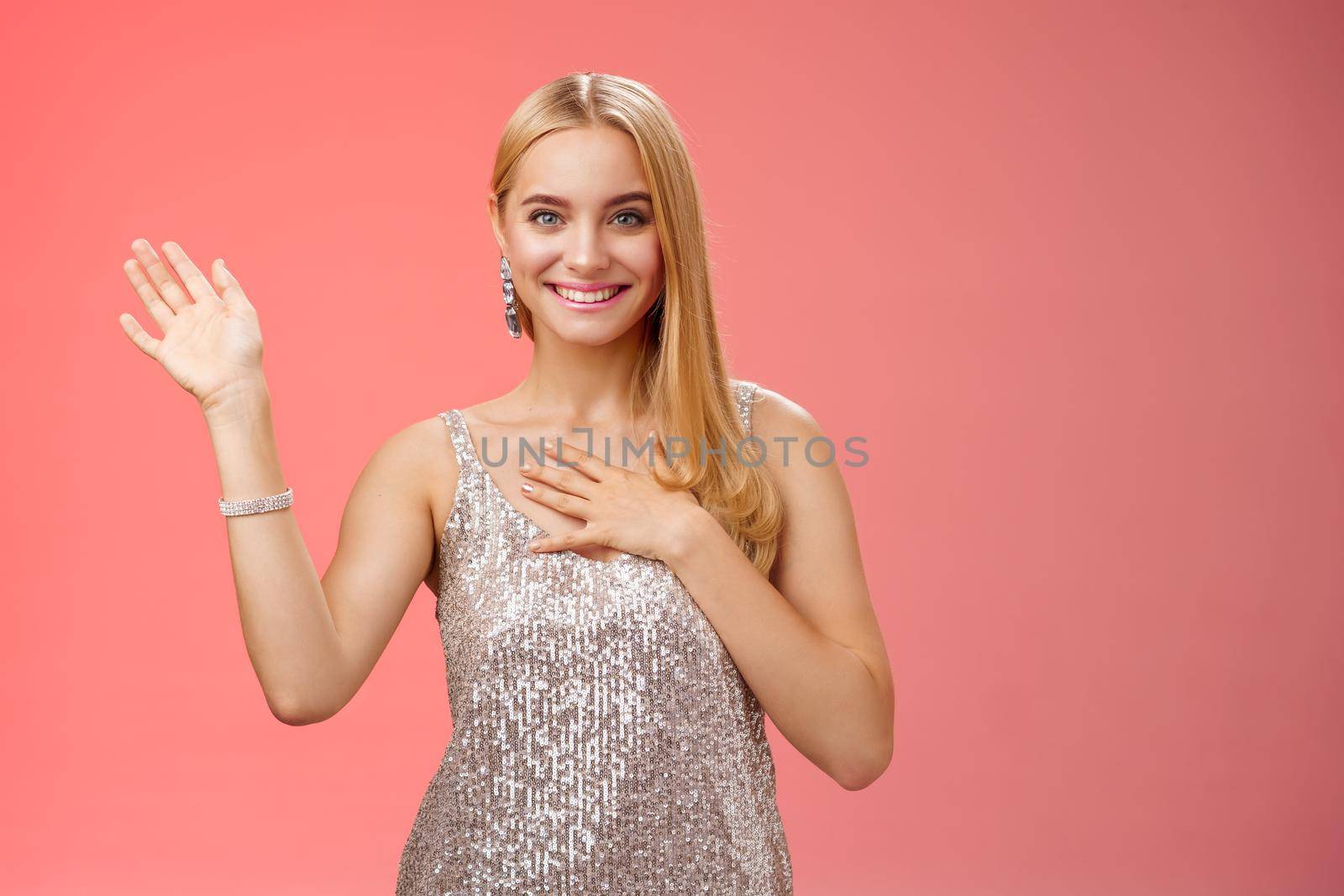 Happy blond girl say hi introduce herself boyfriend friends raise hand waving hello hi gesture press palm chest sincere smiling broadly tell truth swearing, promise keep secret friendly gaze camera.