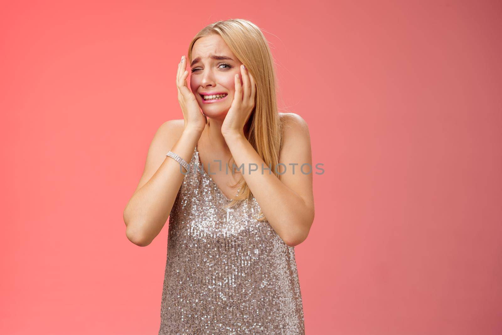 Concerned blond girlfriend panic feel afraid insecure unsafe anxiously turning face cover head look lost frightened assault victim in nightclub scared standing terrified in silver dress by Benzoix