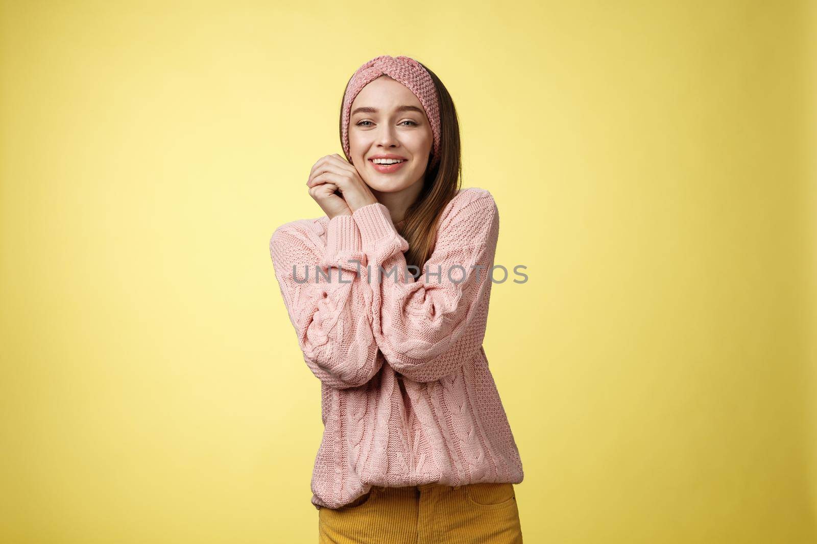 Cheerful glamour young pretty european female in pink cozy knitted headband, sweater leaning on hands pressing palms together silly seeing cute animal, feeling delight compassion, tender emotions by Benzoix