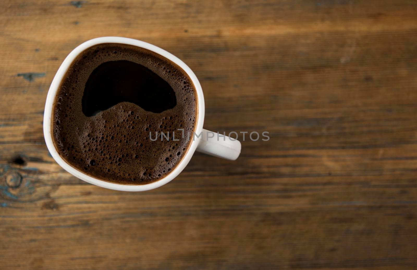 Top view of coffee cup on a wood background with copy space. Close up