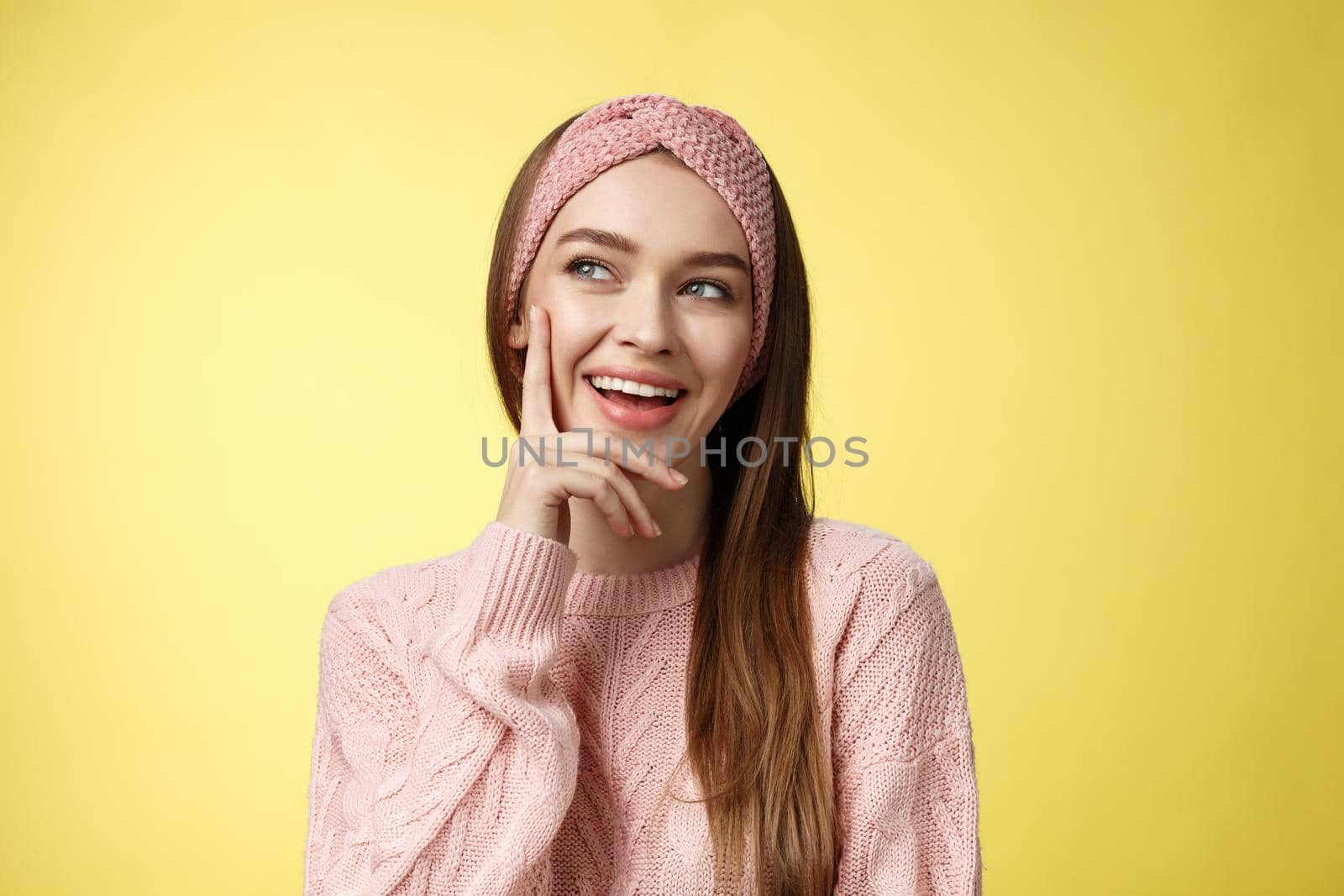 Girl having great idea, smirking delighted, proud herself, touching cheek smiling amused creating plan in mind looking at upper left corner pleased, intrigued and excited seeing awesome opportunity.