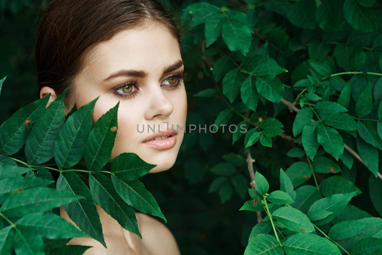 beautiful woman green leaves clean skin nature summer Lifestyle. High quality photo