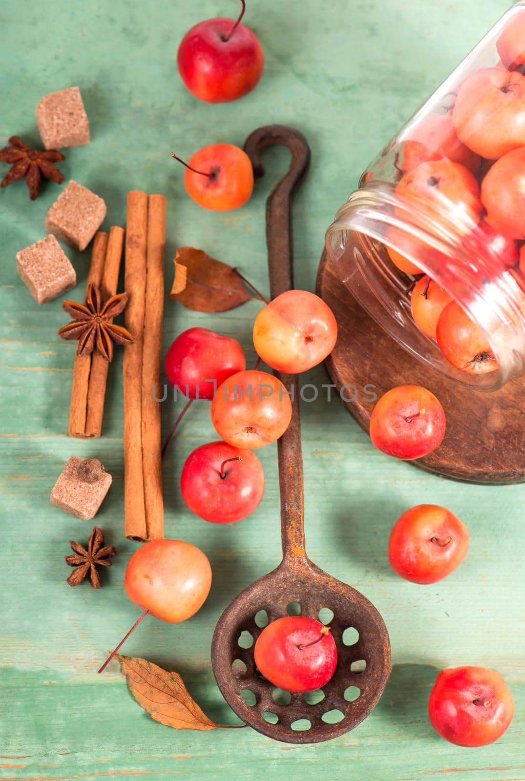 paradise apples, on the wooden table in the rustic style, iron mug