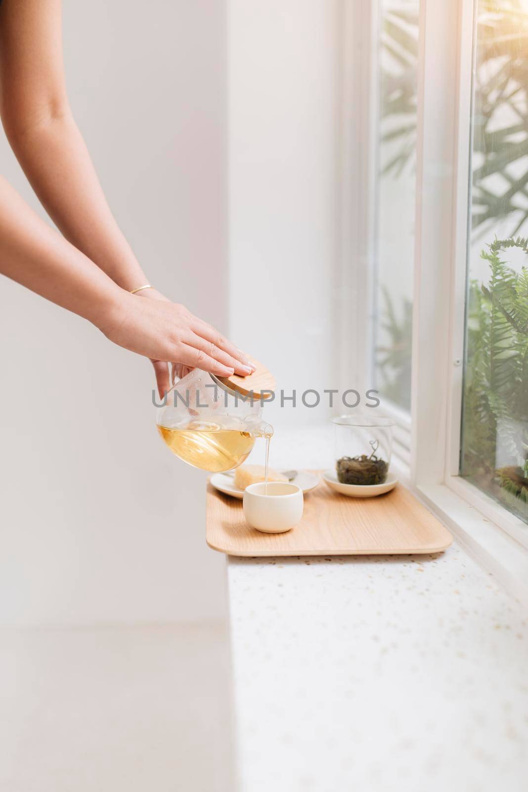 Happy young asian woman tea near window in the morning