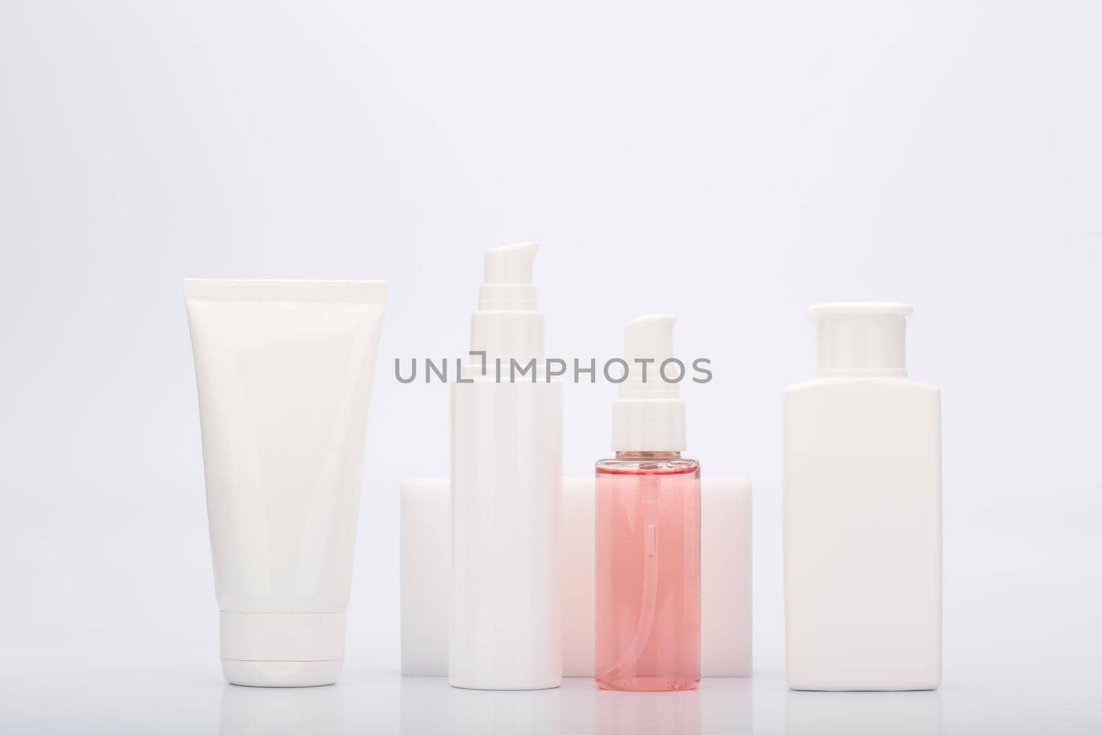 Set of beauty cosmetic products for daily skin care in white tubes isolated on white background. Face cream, lotion, cleansing foam, mask or scrub on white background. Concept of facial treatment 