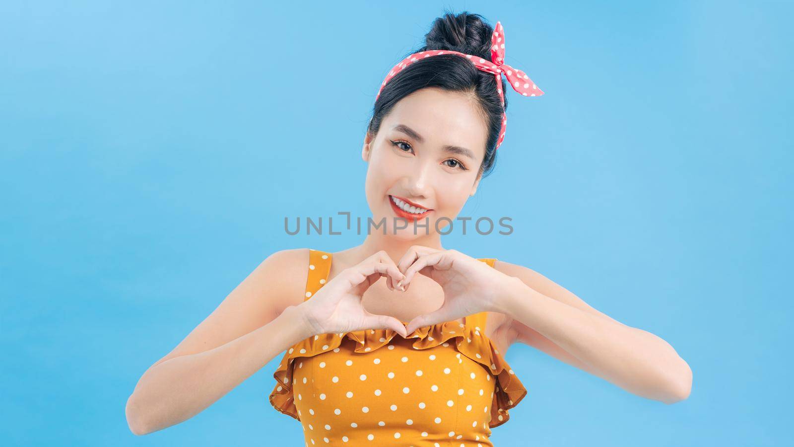 Beautiful woman forming a heart with her hands by makidotvn