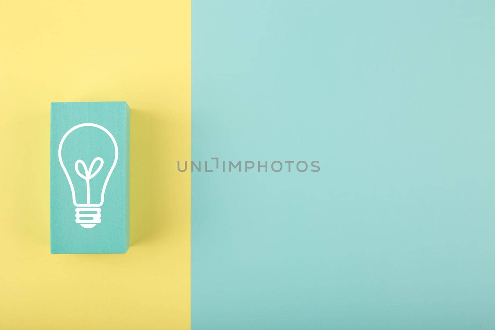 Creativity concept. Light bulb drawn on rectangle on yellow and blue background with copy space by Senorina_Irina