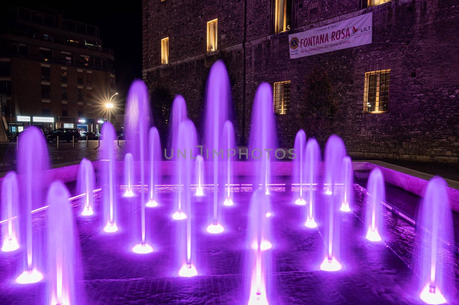 fountain of the town of terni illuminated in pink by carfedeph