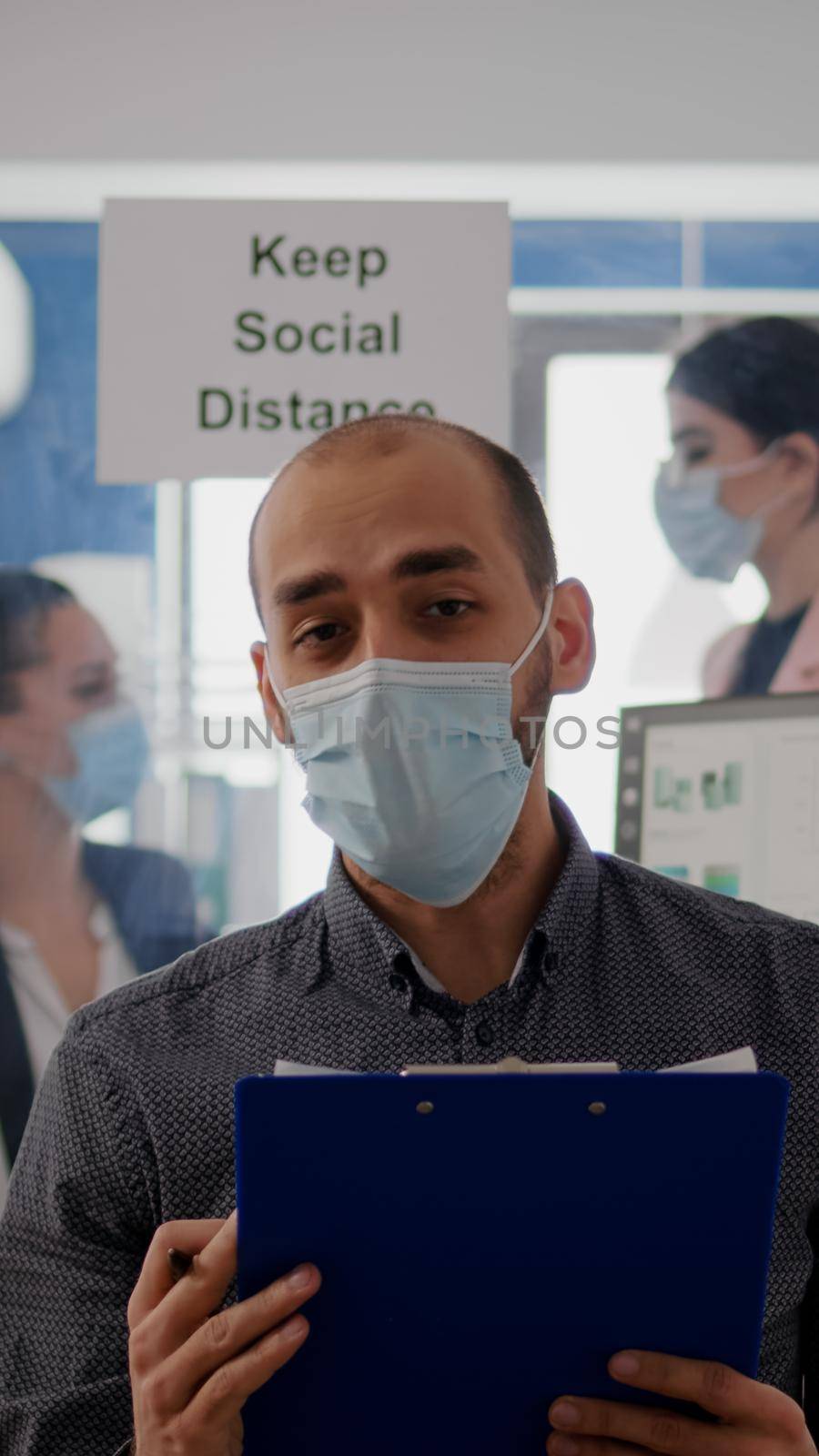 Pov of businessman in face mask to avoid infection talking on online video call conference by DCStudio
