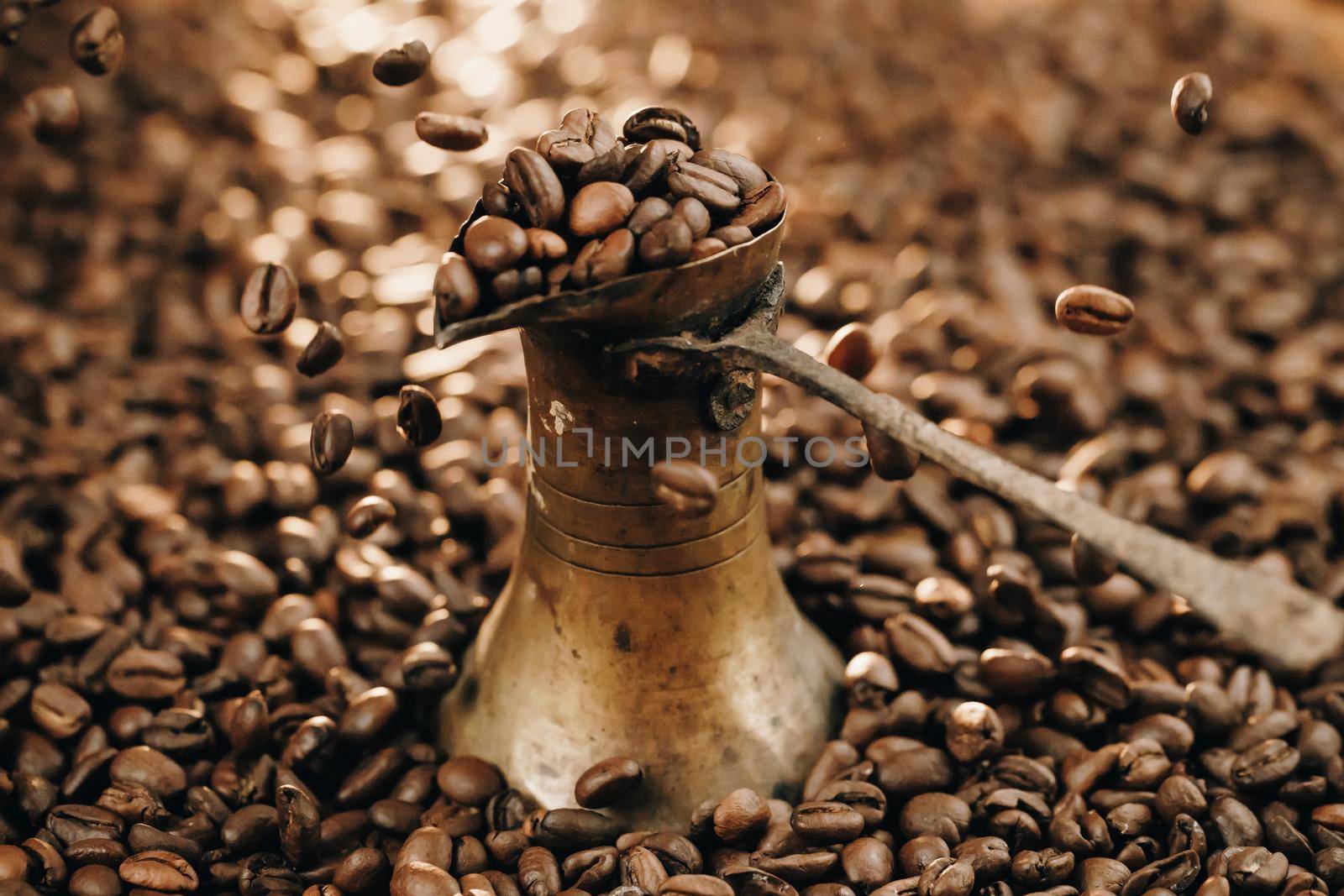 Turkish Coffee Pot and Coffee grains are scattered on the beans surface