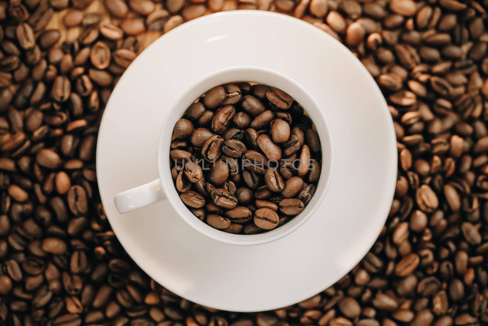 View from top Coffee cup with roasted coffee beans on wooden background