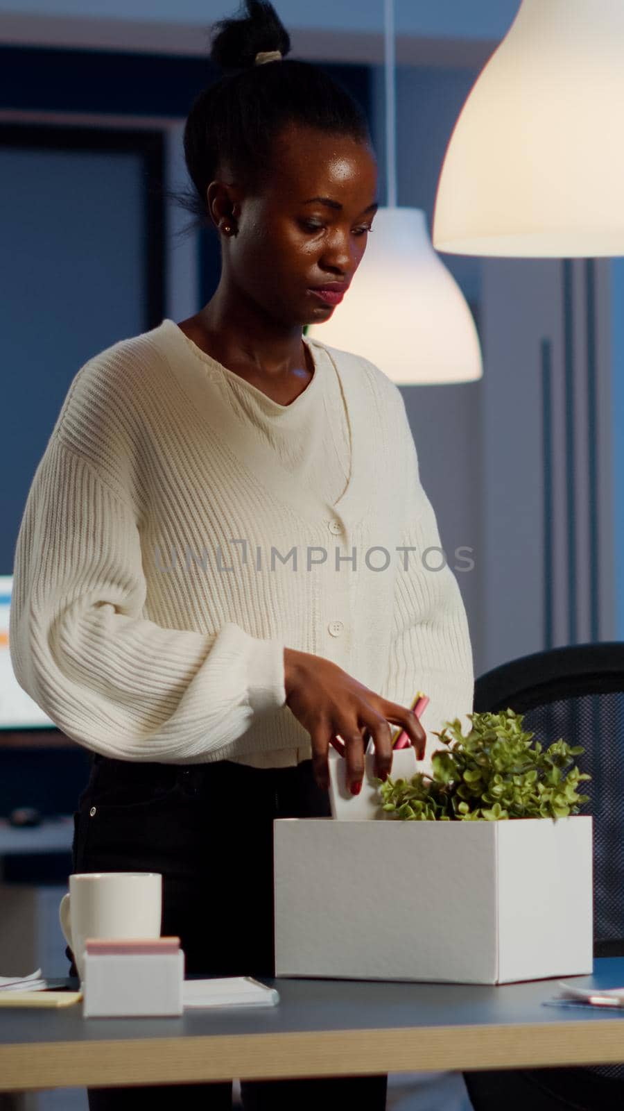 Upset dismissed black woman employee putting stuff in box by DCStudio