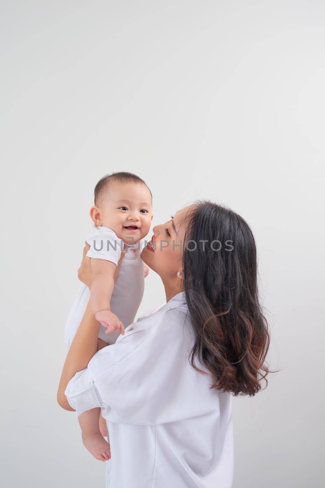 happy family mother playing and hug with baby daughter