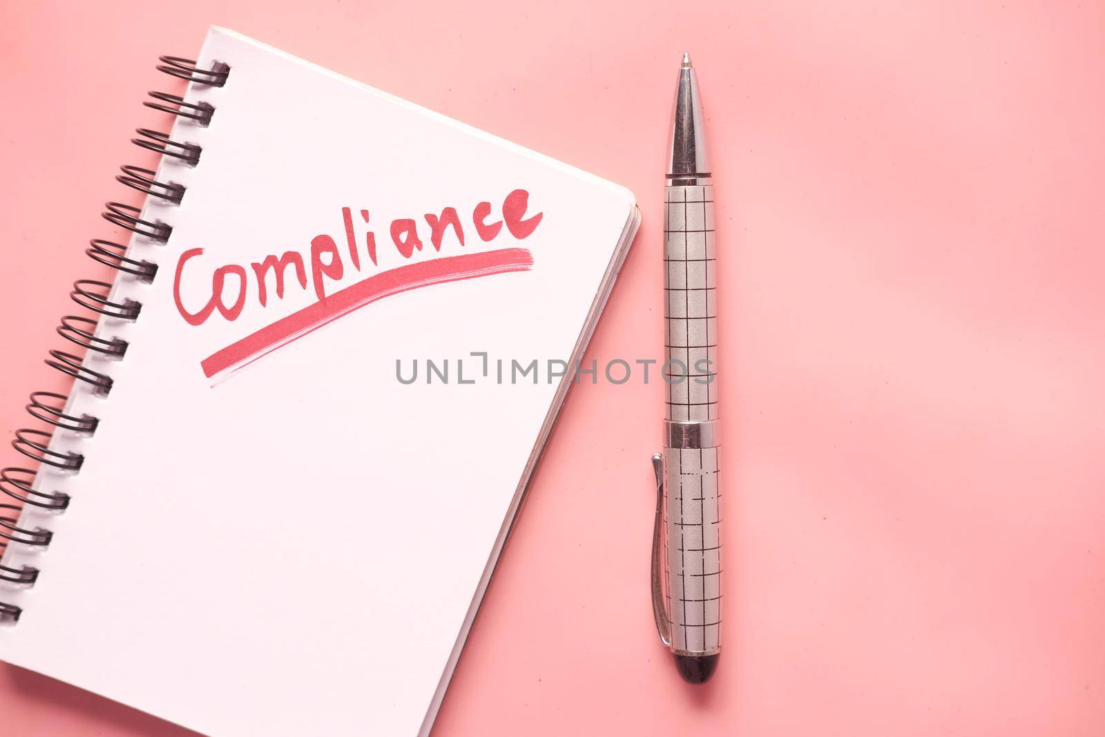 close up of hand written Compliance text on notepad by towfiq007