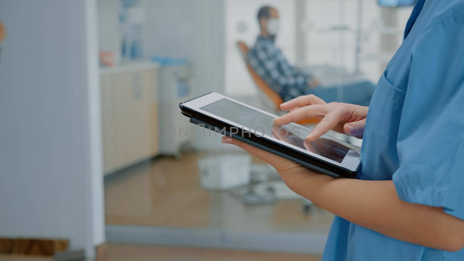 Close up of modern tablet with touchscreen and nurse hand by DCStudio