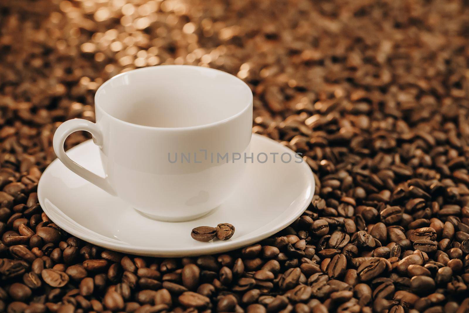 Coffee cup with roasted coffee beans on wooden beans table