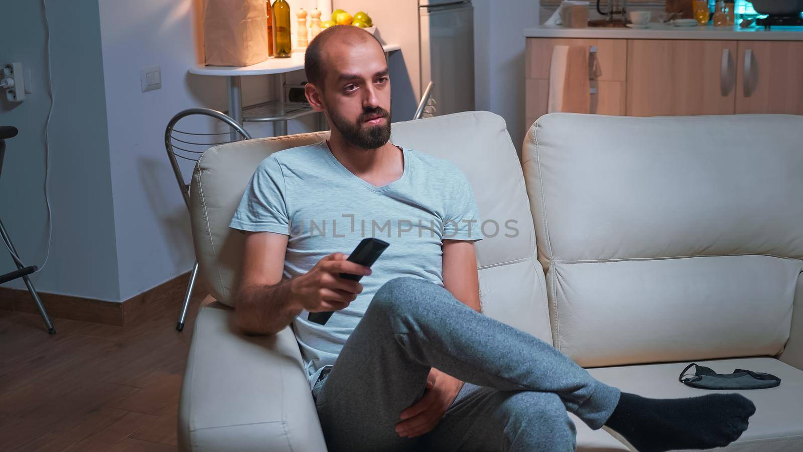 Portrait of concentrated man watching entertainment shows series by DCStudio
