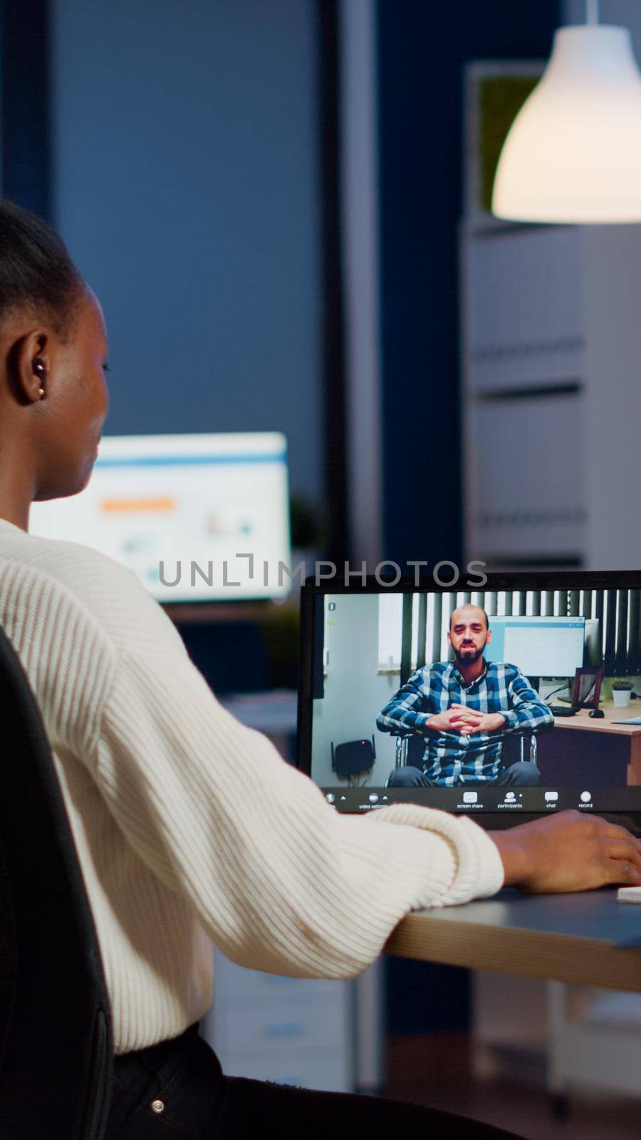 African manager with headphones waving at camera talking with remote disabled employee, overworking using laptop. Woman working in start up financial company havig online meeting, virtual discussing