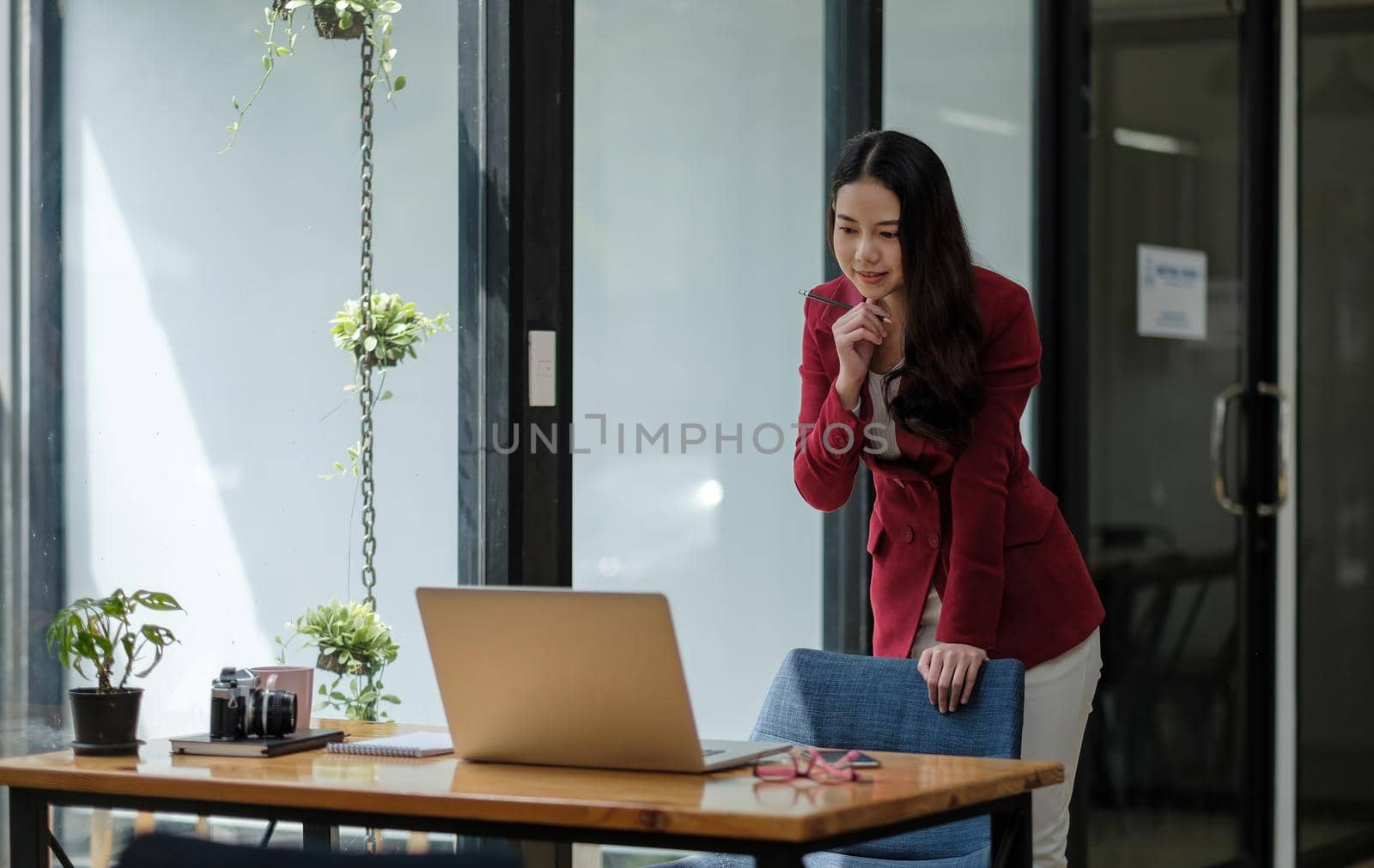 Asian business woman working with thinking moment on laptop. in coffee shop cafe