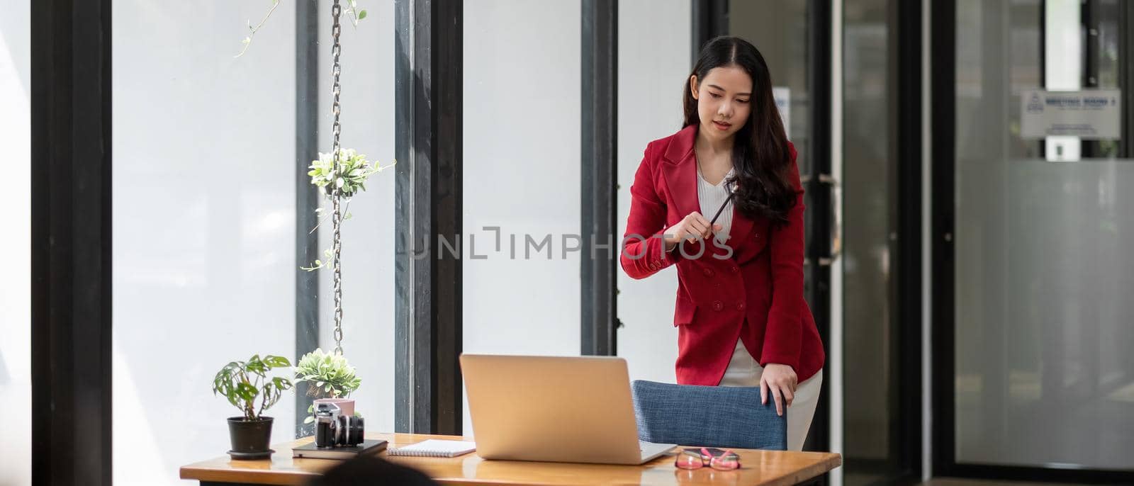 Asian business woman working with thinking moment on laptop. in coffee shop cafe, banner aspect. by nateemee