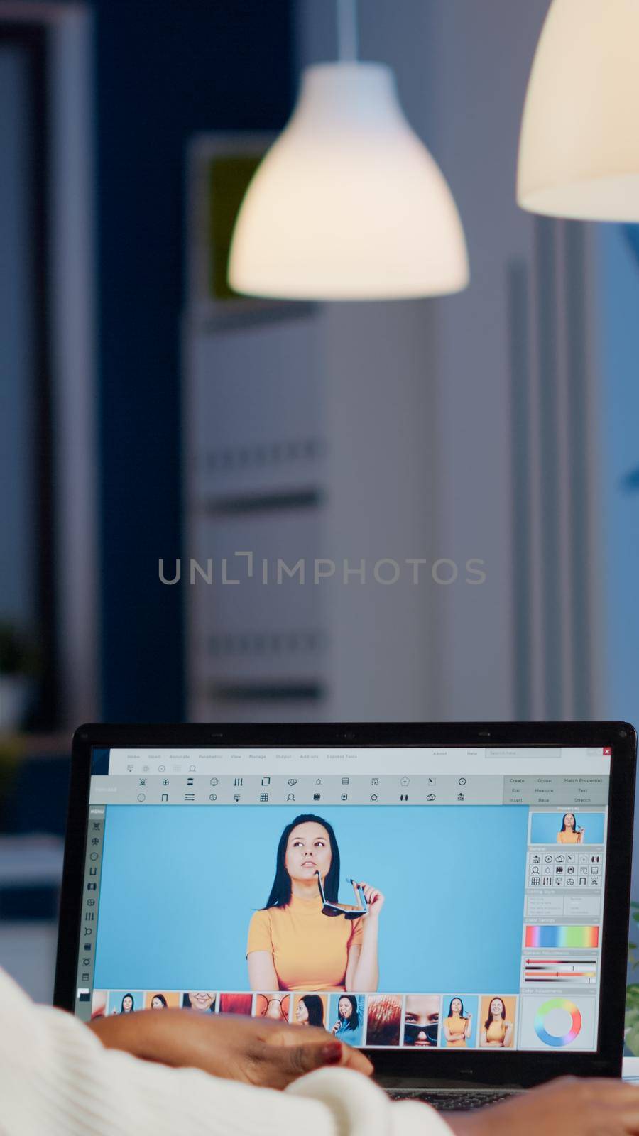 African professional woman photo retoucher working on laptop at new project in business office at night time. Content creator doing portrait retouching, artist, occupation, screen, graphic