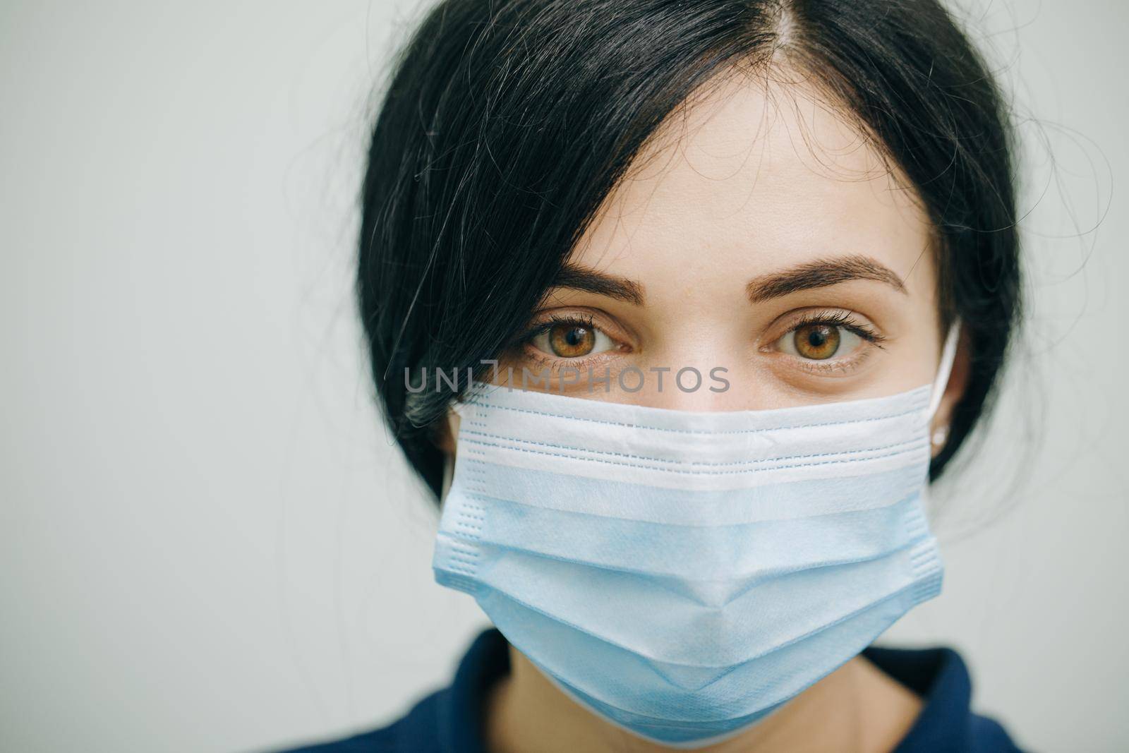 Health Protection Corona Virus Concept. Young woman in medical mask. Female breathes deeply and looking at camera by uflypro
