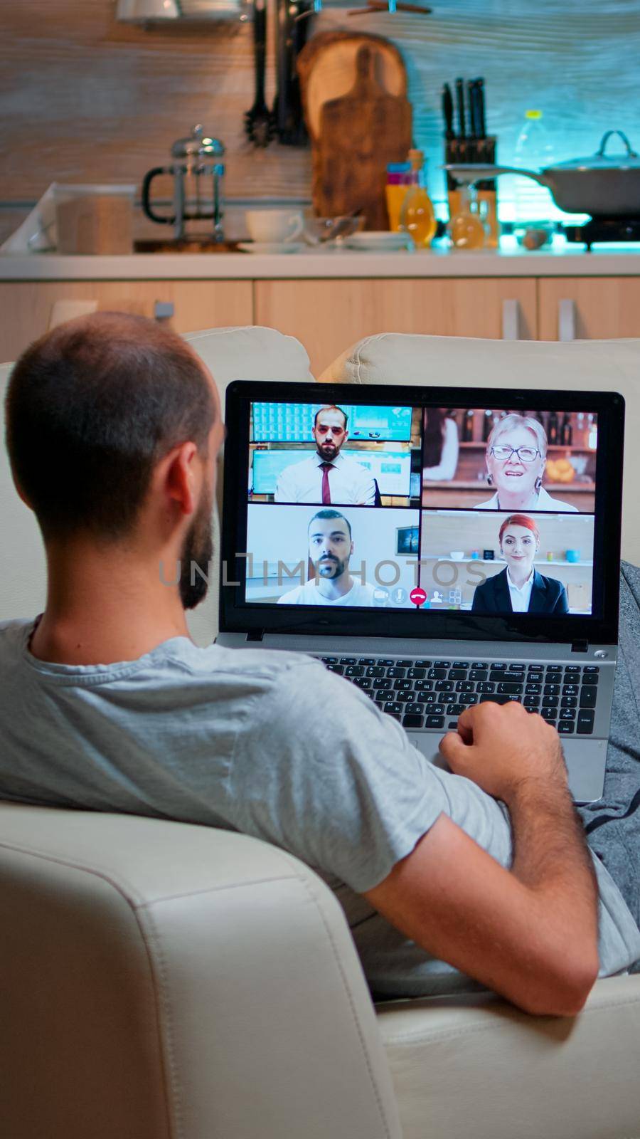 Caucasian male talking with collegues during video call conference by DCStudio