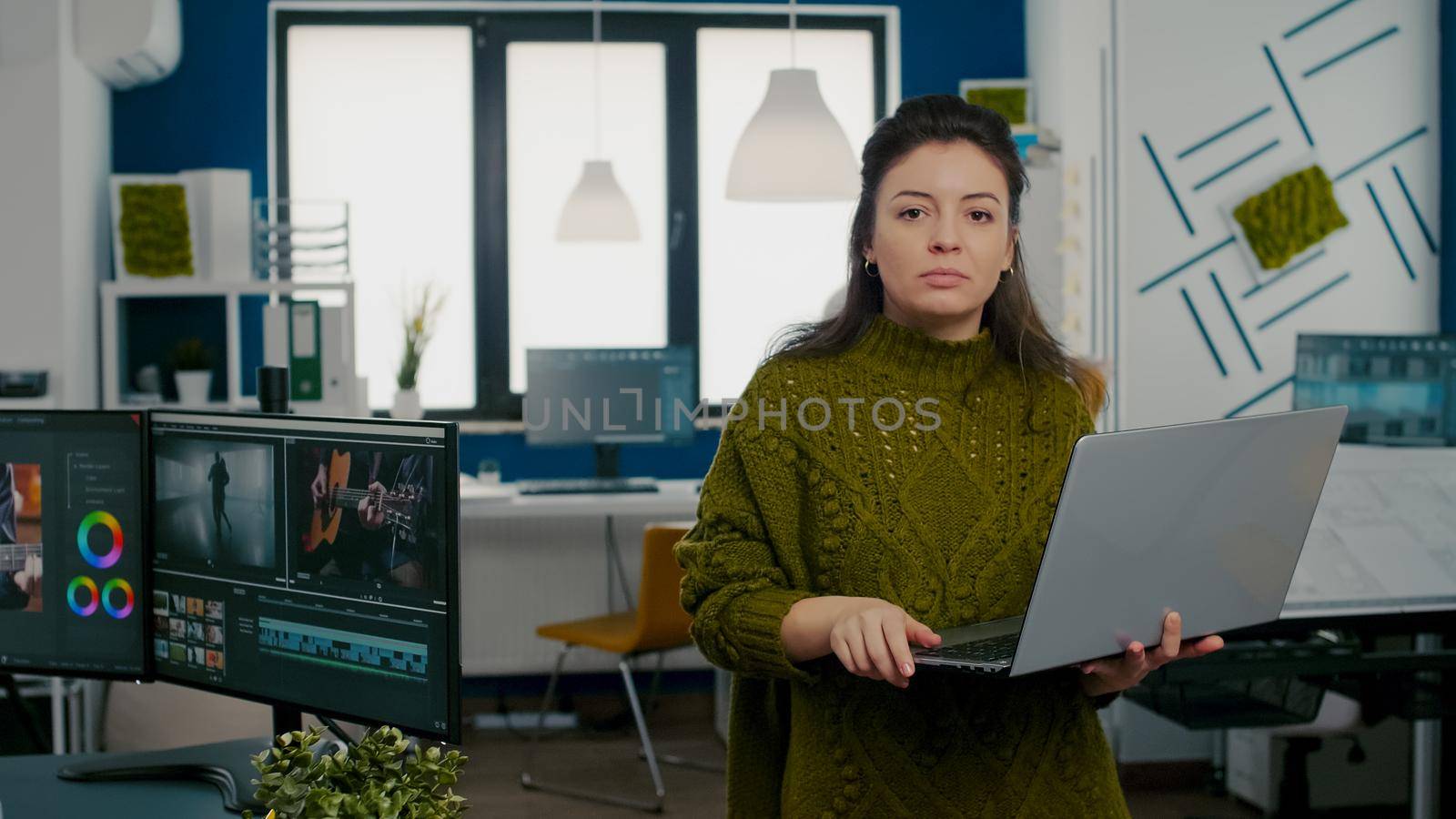 Employee looking at camera smiling standing in front of camera by DCStudio